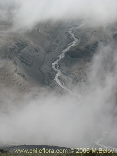 An  image of a river flowing, viewed from above through the clouds, Mondaca Trail, Radal Siete Tasas National Park, Chile.