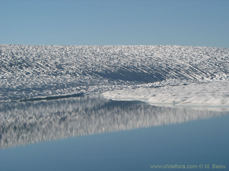 A view of snow and ice-covered Las Animas Lake on the Mondaca Trail from Radal Siete Tazas, Chile.