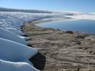 A view of a shore of snow and ice- covered Las Animas Lake on the Mondaca Trail from Radal Siete Tazas, Chile.