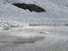 A view of snow and ice-covered Las Animas Lake on the Mondaca Trail from Radal Siete Tazas, Chile.