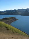 Image of a green coast of Laguna Maule (Maule Lake).