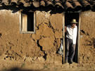 An image of an Adobe House with a Man