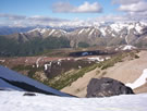 A view into a mountain valley, partially covered with snow, Radal Siete Tasas National Park.