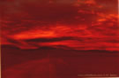 An image of a road which goes from Panamericana Highway to Salar de Pajonales at sunset in very red tones, Chile.