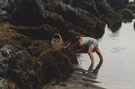 An image of young a girl gathering seaweeds at Boyeruca, Chile.