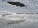 Vaporized Reflections:  A view of snow and ice-covered Las Animas Lake on the Mondaca Trail from Radal Siete Tasas, Chile.