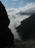 The Battle of Elements:  Image of clouds pouring into the valley, Mondaca Trail, Chile.