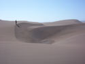 Timelessness:  An image of Putu dunes with a person standing on one side.