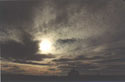 Death Reminder:  An image of a grave in the Atacama desert with dark clouds in the sky, Chile.